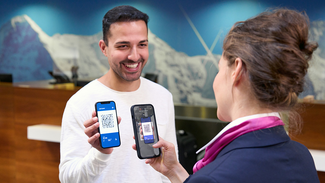 Flight attendant checking qr code boarding pass using barcode scanning on a smartphone